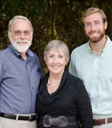 Drs. Sutton, Jacquelene and MacKenzie Farnham standing together outdoors.