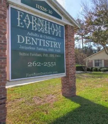 The Farnham Dentistry sign and the single-storey brick office behind it.