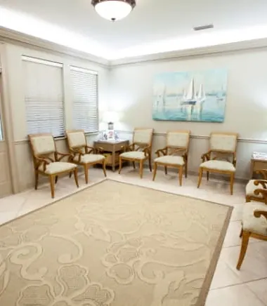 The Farnham Dentistry waiting room, with upholstered chairs along the walls.