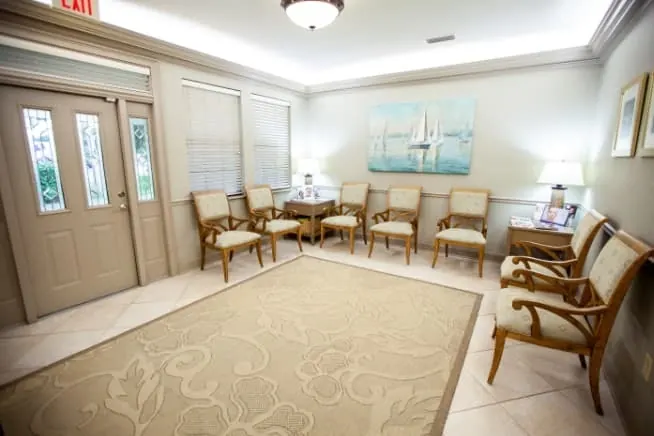 The Farnham Dentistry waiting room, with chairs along the walls and framed prints.